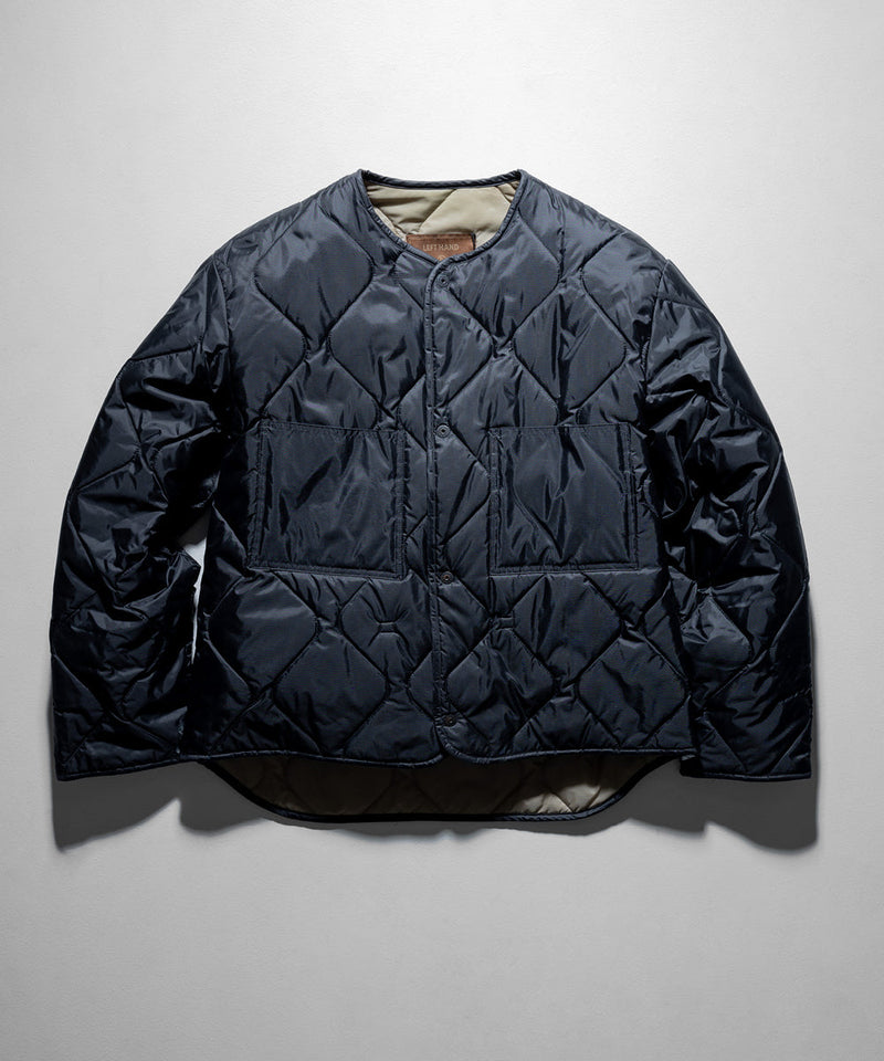 Left Hand Jacket Liner in black with diamond quilted design, front pockets and round neckline.