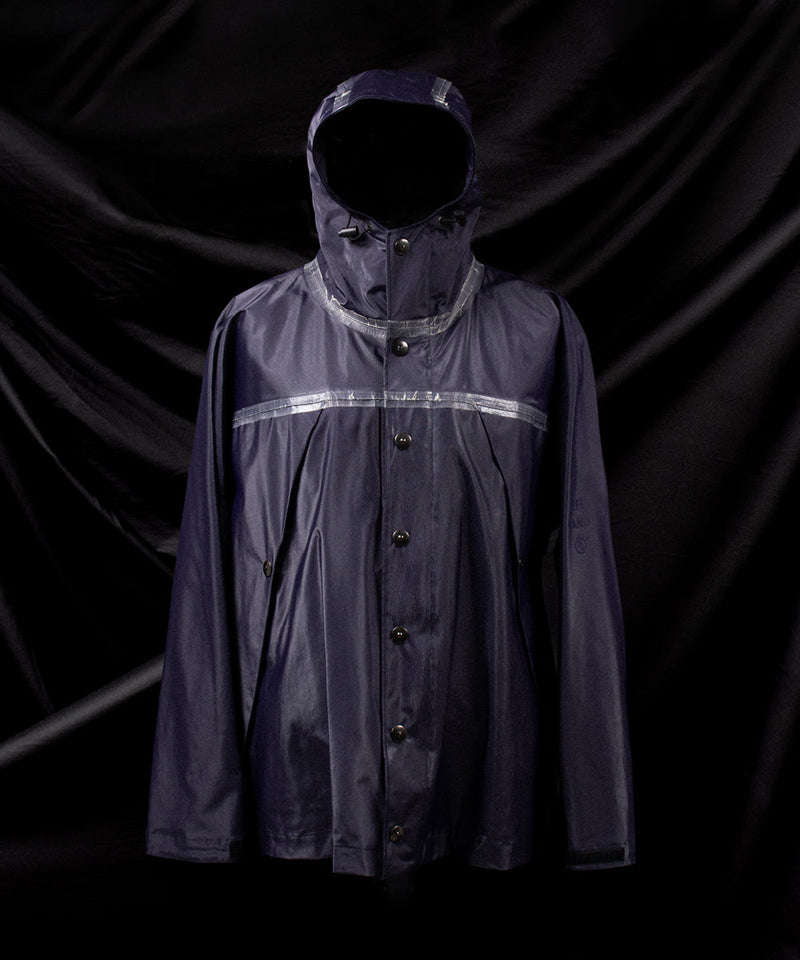 Left Hand Thermojoint Jacket with button fastening, hood and reflective seam details, displayed against a dark fabric backdrop.