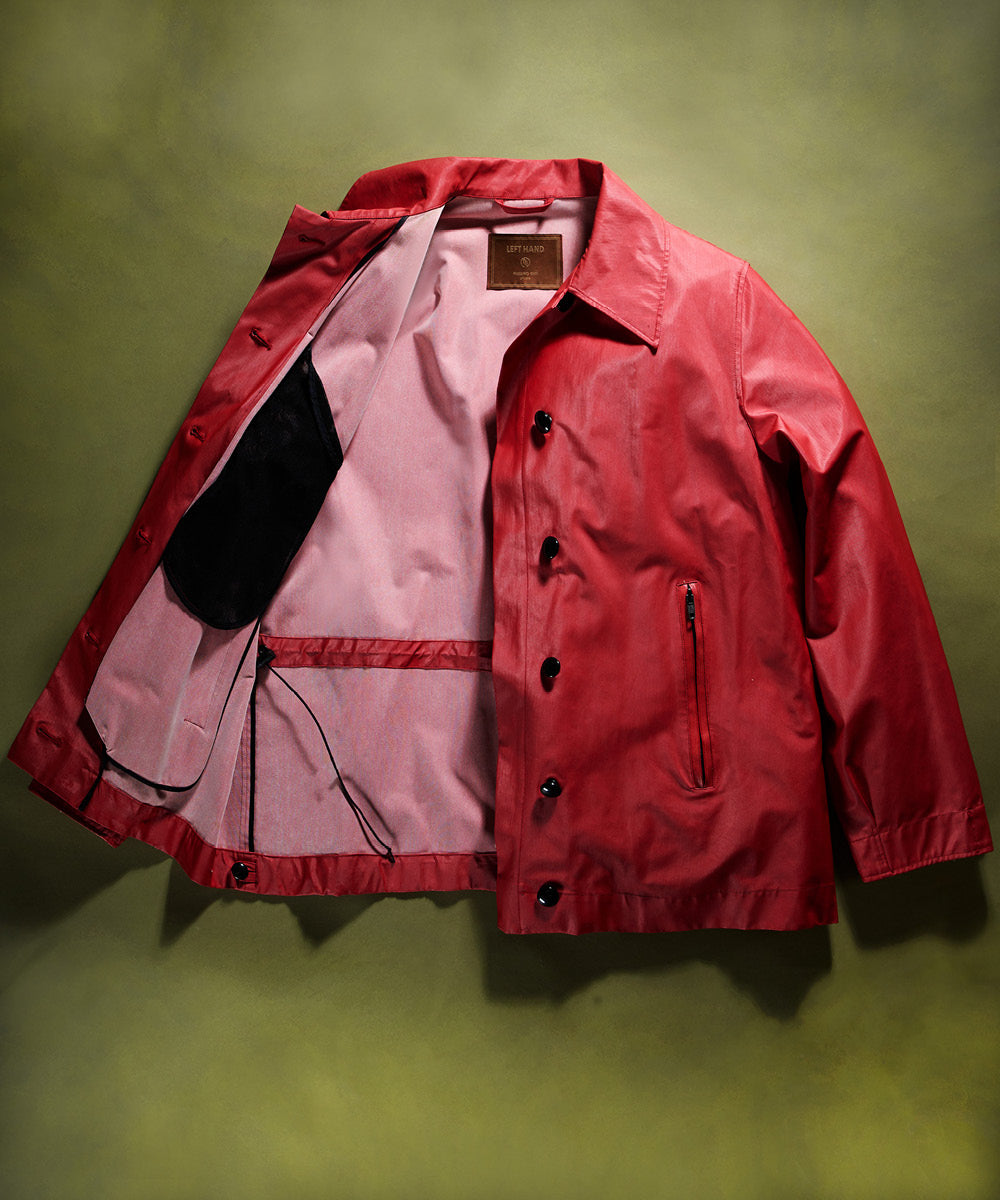 Left Hand Red Thermojoint Ladies Harrington jacket with a pink lining on a green background